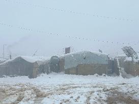 Snowstorms hit Syrian refugee camps.