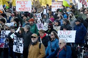 Anti-ICE protesters gather outside the US Immigration and Customs Enforcement (ICE)  headquarters