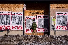 A Person Walks Past Signage For Renee Good - Minneapolis