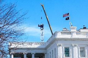 A tower crane is built in the White House Ballroom construction zone where the East wing previously stood at the White House