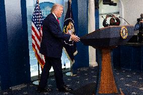 US President Trump speaks on to reporters ahead of trip to Davos