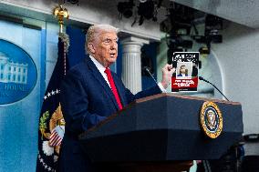 US President Trump speaks on to reporters ahead of trip to Davos