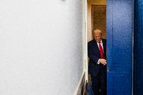 US President Trump speaks on to reporters ahead of trip to Davos