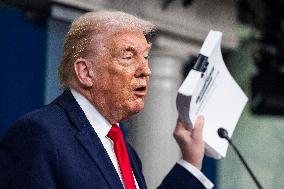 US President Trump speaks on to reporters ahead of trip to Davos