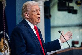 US President Trump speaks on to reporters ahead of trip to Davos