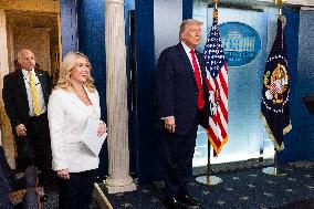 US President Trump speaks on to reporters ahead of trip to Davos