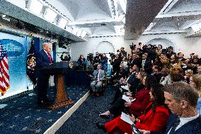 US President Trump speaks on to reporters ahead of trip to Davos