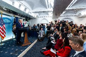 US President Trump speaks on to reporters ahead of trip to Davos