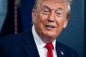 US President Trump speaks on to reporters ahead of trip to Davos