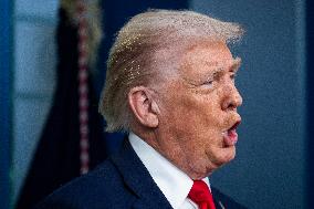 US President Trump speaks on to reporters ahead of trip to Davos