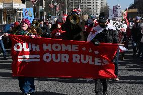 People protest on the first anniversary of President Donald Trump's second term in office