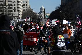 People protest on the first anniversary of President Donald Trump's second term in office