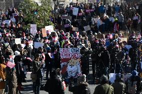 People protest on the first anniversary of President Donald Trump's second term in office