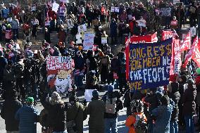 People protest on the first anniversary of President Donald Trump's second term in office