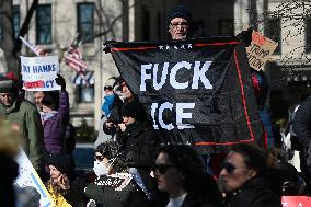 People protest on the first anniversary of President Donald Trump's second term in office
