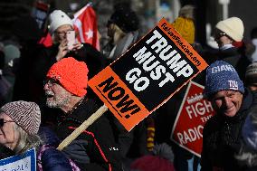 People protest on the first anniversary of President Donald Trump's second term in office