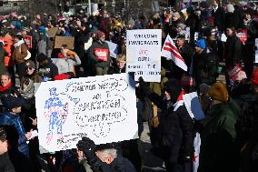 People protest on the first anniversary of President Donald Trump's second term in office