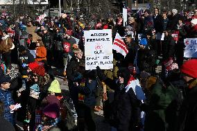 People protest on the first anniversary of President Donald Trump's second term in office