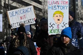 People protest on the first anniversary of President Donald Trump's second term in office