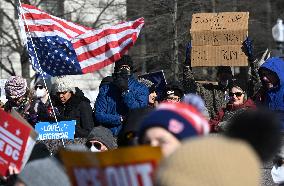 People protest on the first anniversary of President Donald Trump's second term in office