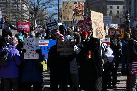 People protest on the first anniversary of President Donald Trump's second term in office