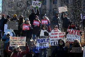 People protest on the first anniversary of President Donald Trump's second term in office