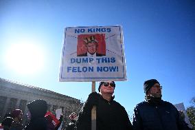 People protest on the first anniversary of President Donald Trump's second term in office