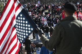 People protest on the first anniversary of President Donald Trump's second term in office