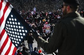 People protest on the first anniversary of President Donald Trump's second term in office