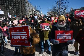 People protest on the first anniversary of President Donald Trump's second term in office