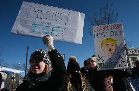 People protest on the first anniversary of President Donald Trump's second term in office