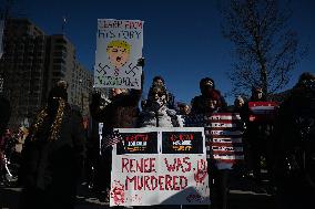 People protest on the first anniversary of President Donald Trump's second term in office