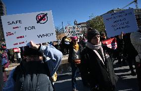 People protest on the first anniversary of President Donald Trump's second term in office