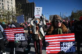 People protest on the first anniversary of President Donald Trump's second term in office