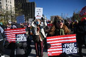 People protest on the first anniversary of President Donald Trump's second term in office