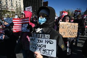 People protest on the first anniversary of President Donald Trump's second term in office