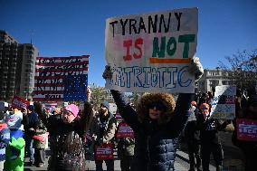 People protest on the first anniversary of President Donald Trump's second term in office