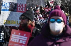 People protest on the first anniversary of President Donald Trump's second term in office