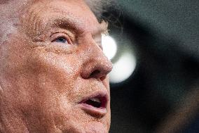 US President Trump speaks on to reporters ahead of trip to Davos