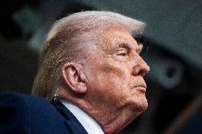 US President Trump speaks on to reporters ahead of trip to Davos