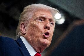 US President Trump speaks on to reporters ahead of trip to Davos