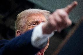 US President Trump speaks on to reporters ahead of trip to Davos