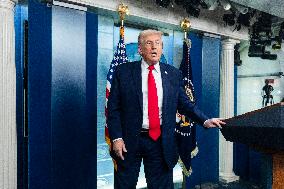 US President Trump speaks on to reporters ahead of trip to Davos