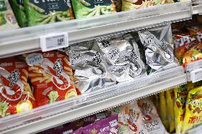 Black-and-white Calbee snack packages