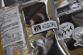 Black-and-white Calbee snack packages